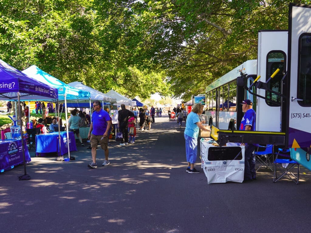 A street full of booths and people.