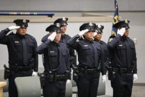 Six police cadets saluting