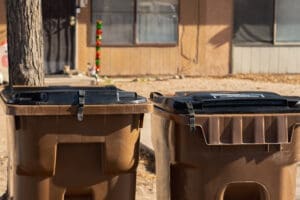 trash carts with different lids, two different latch locations.