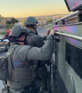 Law Officers on side of an enforcement vehicle