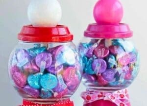 A colorful candy jar full of Chocolate kisses