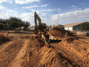 backhoe digging into the dirt