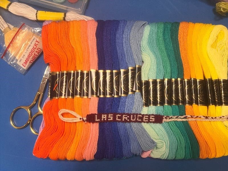 Colorful yarns and scissors laying on a surface