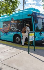 City of Las Cruces electric Bus and man stepping into it.
