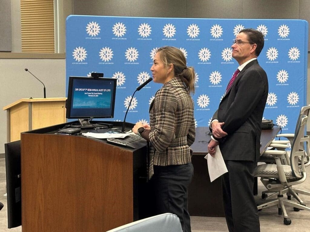 Two people speaking at a podium.