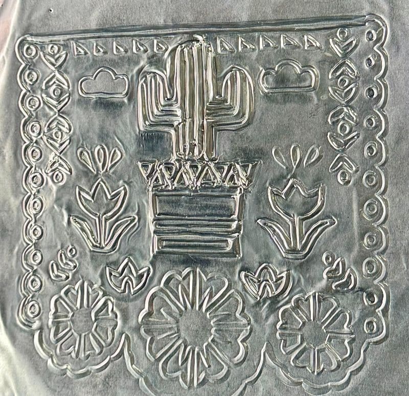 Art piece with cactus and flowers.