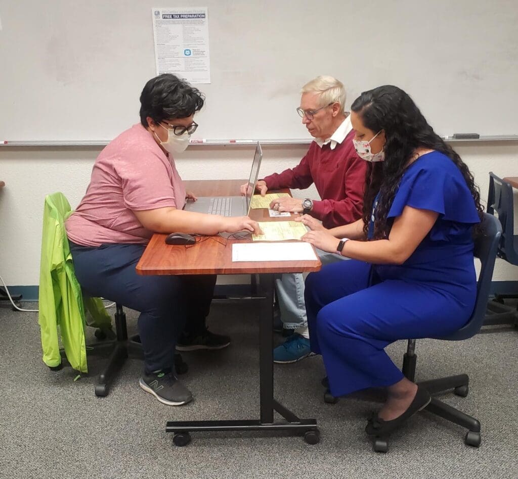 A photo of three people sitting down
