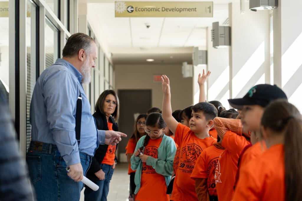 Scott Rogers talking to children.