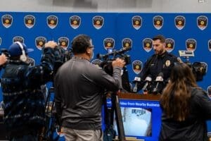 Camera men speaking to police chief.