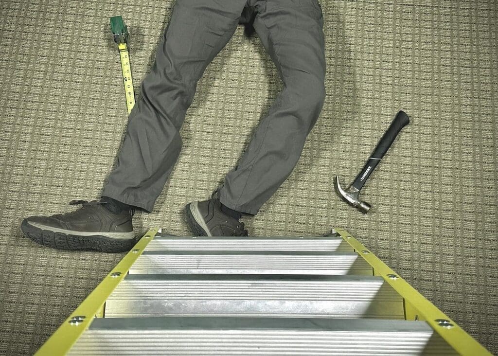 Somebody laying down by a ladder.