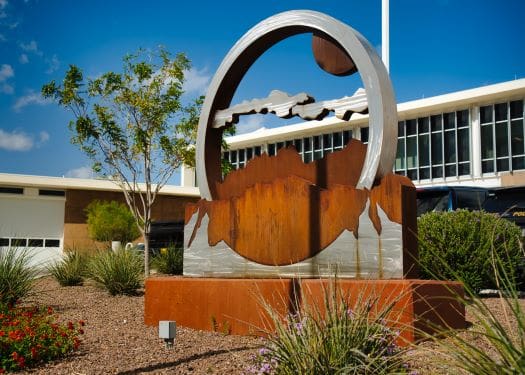 Corten steel sculpture - circle with mountain and cloud outline