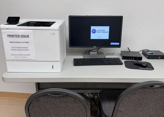 Computer and printer on a table.