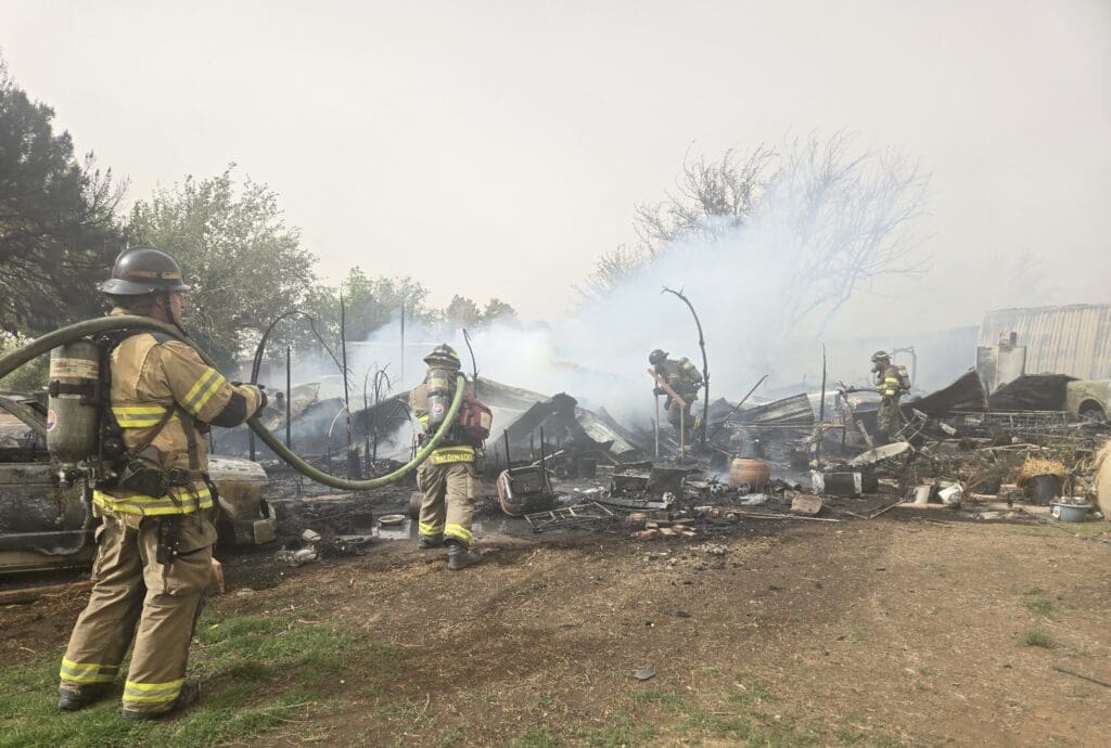 Firefighters battling a mobile home fire.