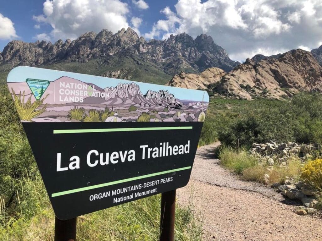 La Cueva Trailhead sign by the trail.