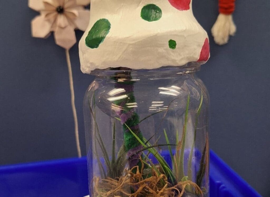 Clear jar with a mushroom-shaped lid.