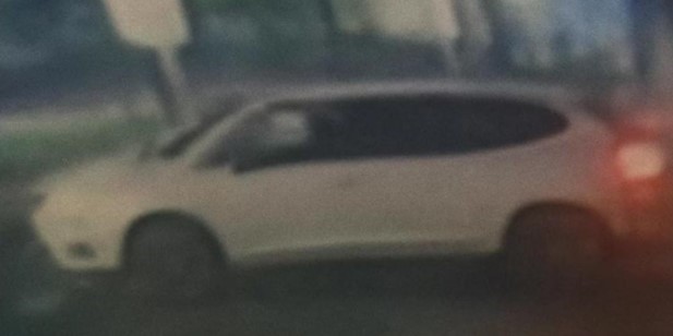 Blurry image of a white SUV.