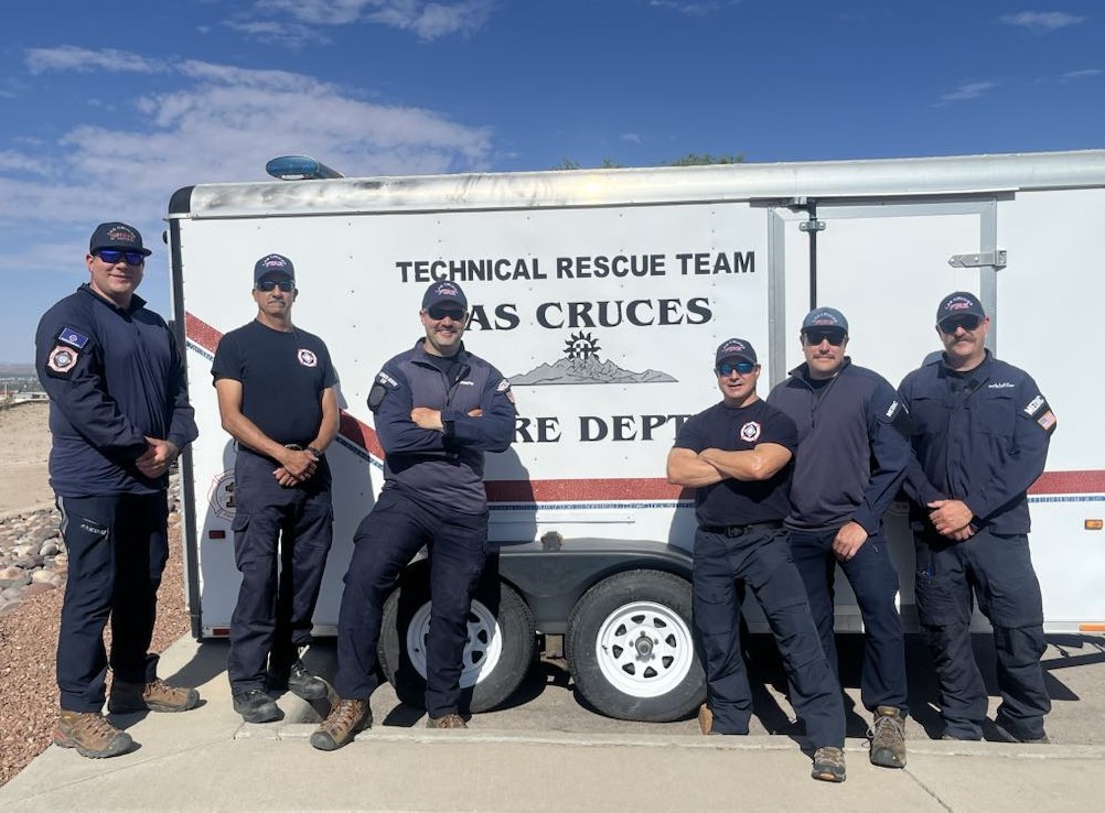 Six firefighters standing in front of the LCFD's Swiftwater Rescue trailer.