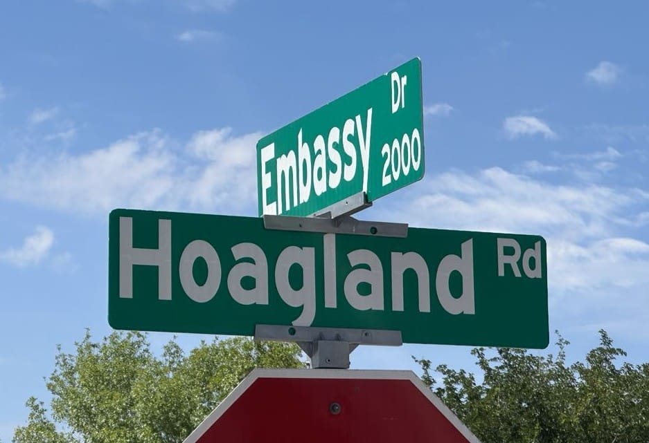 photo of two street signs embassy and hoagland