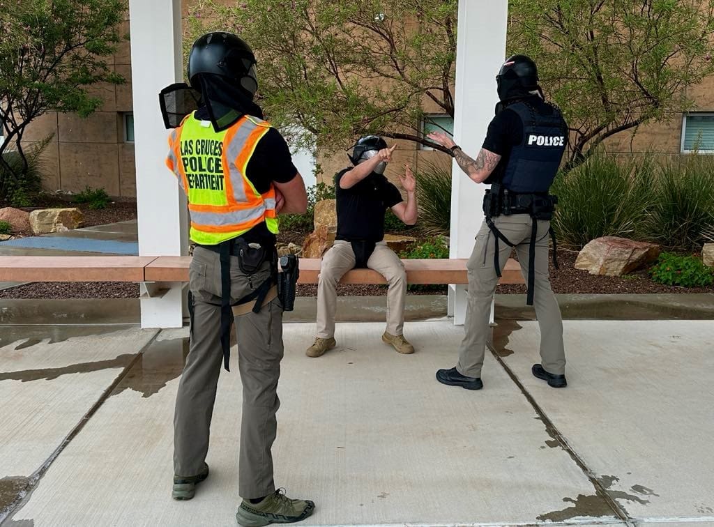 Las Cruce police officers giving demonstrations on reality-based scenarios.
