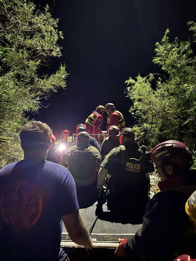 Swiftwater Rescue Team working together at night.