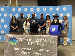 new Utilities interns standing together behind a sign.