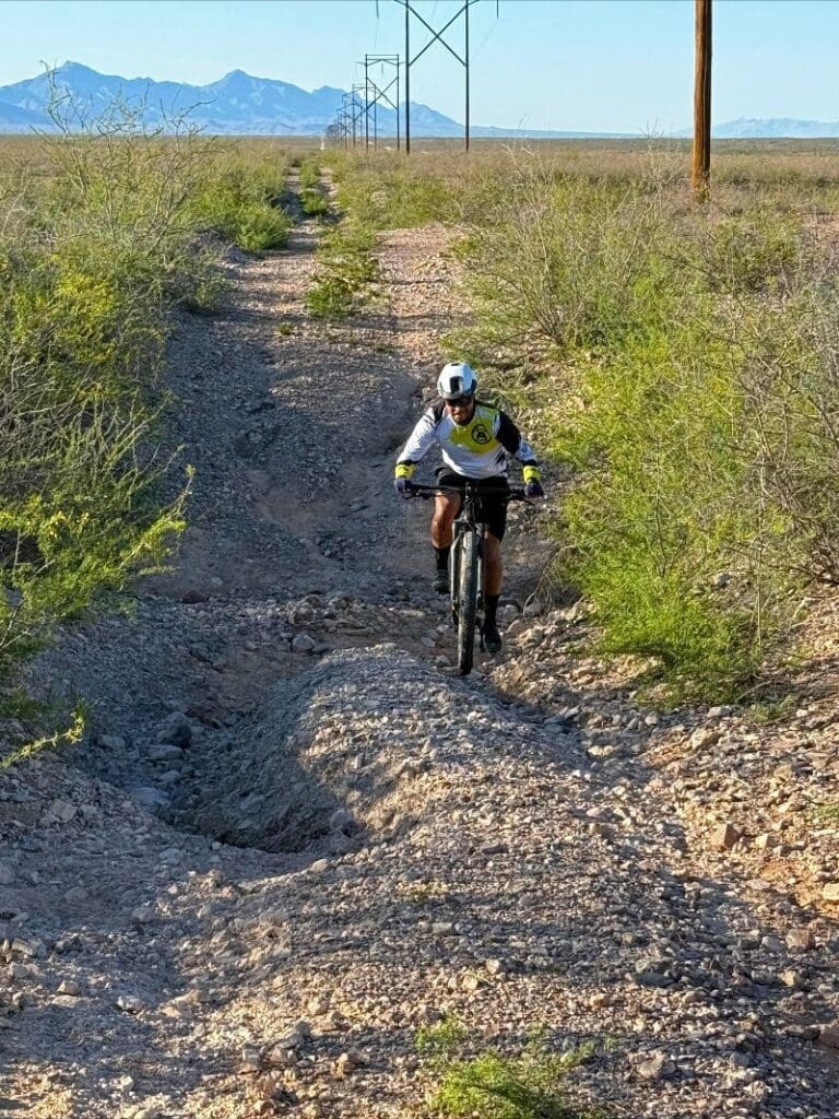 Bicyclist riding on a gravel road.