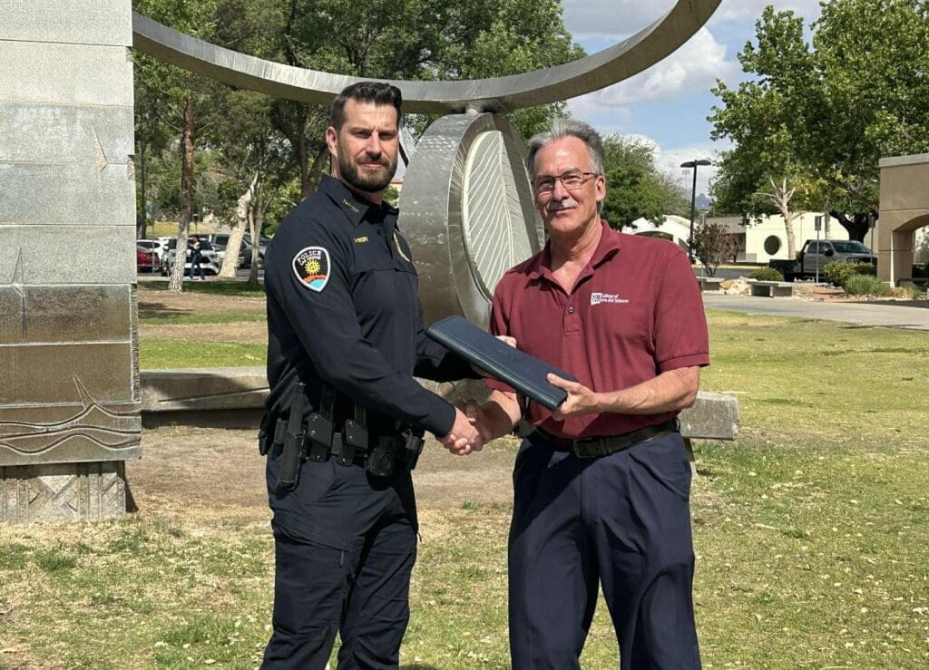 Jeremy Story and Dennis Giever standing in front of a statue.