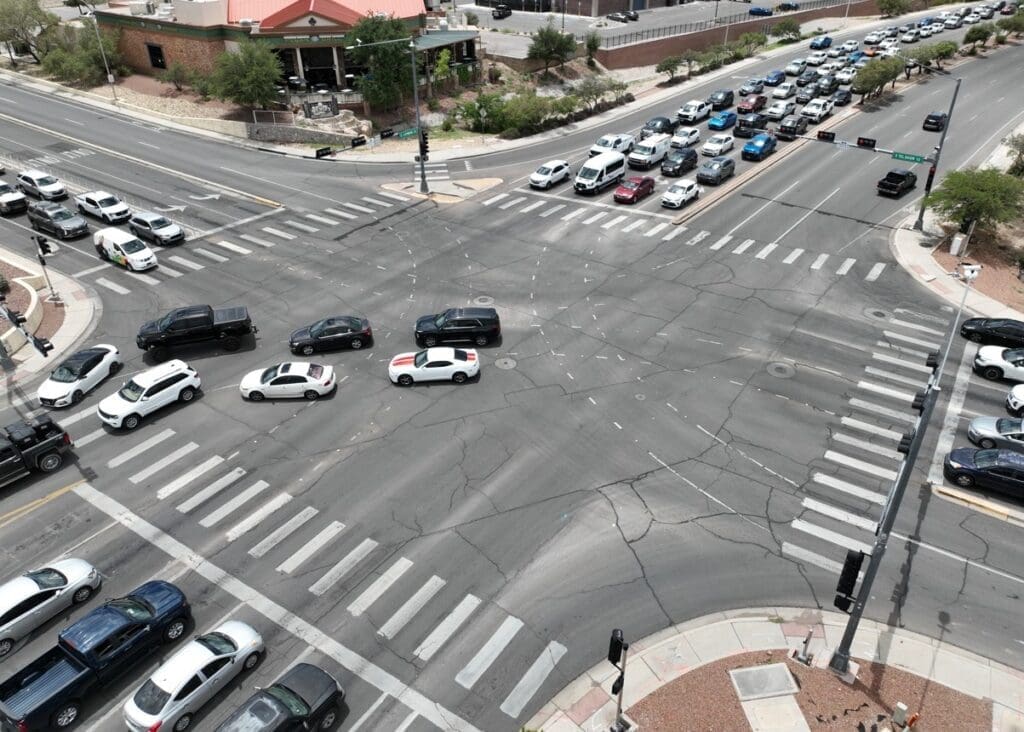 Vehicles waiting their turn at a busy intersection.