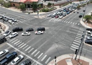 Vehicles waiting their turn at a busy intersection.