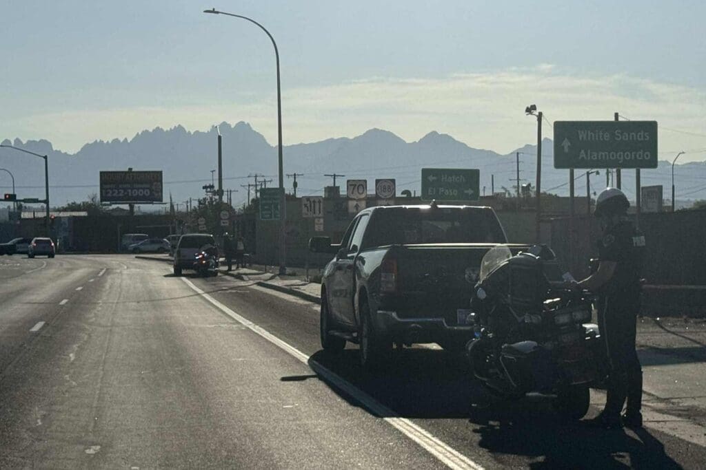 Motorcycle patrol officer stopped behind a truck that he pulled over.