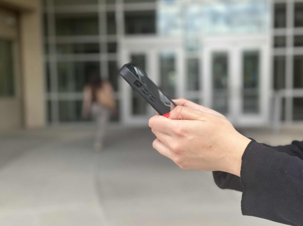 Two hands holding a cell phone.