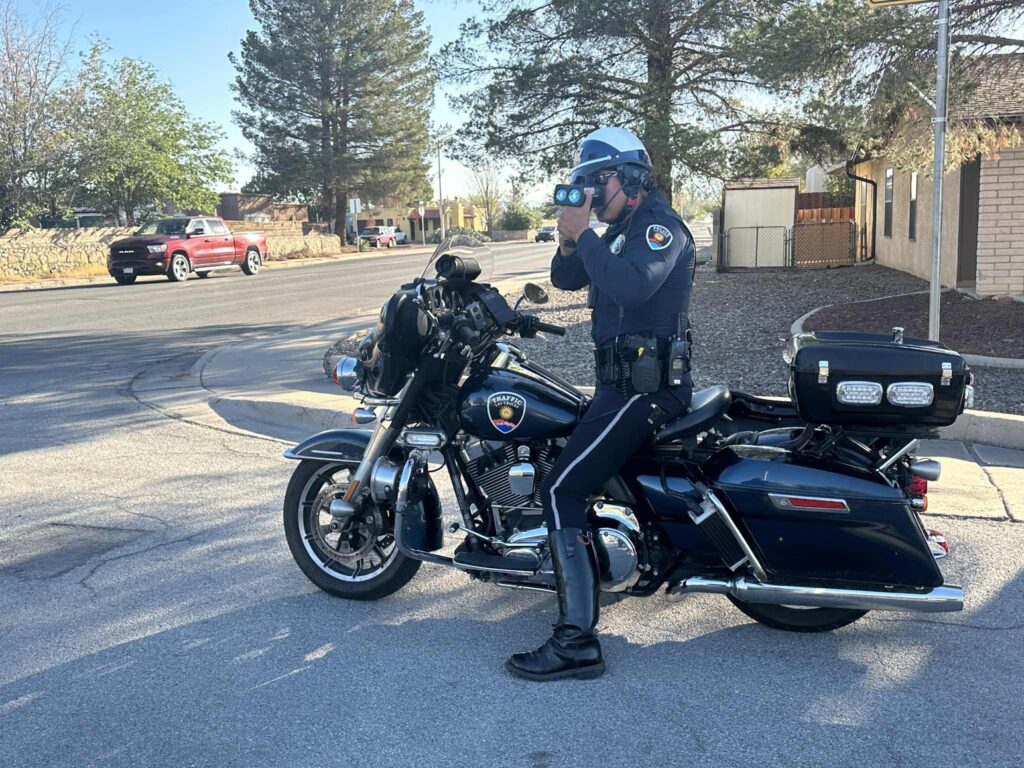 LCPD Motorcycle Officer parked and running radar.