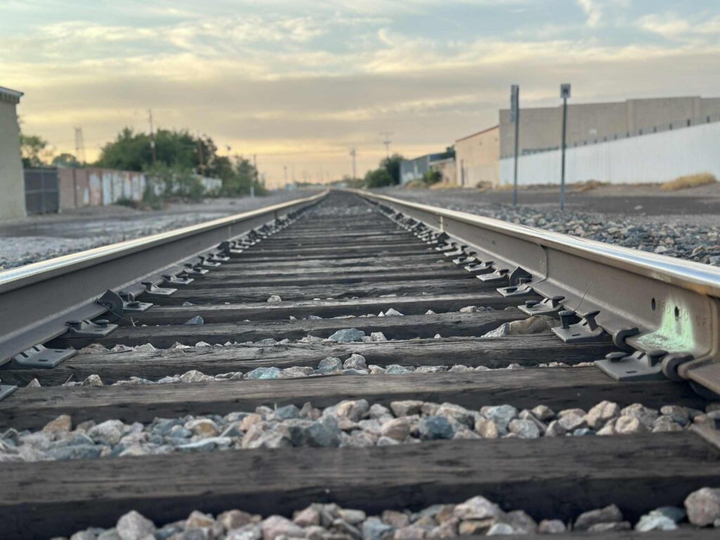 Railroad tracks with buildings on both sides.