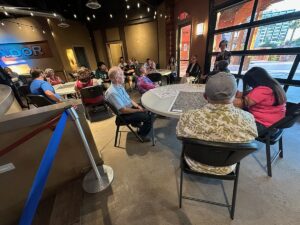 Project team member Jennifer Hurley introduces participants to the their table activity for the evening.
