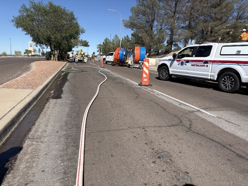 Road crew working on a gas leak in the road.
