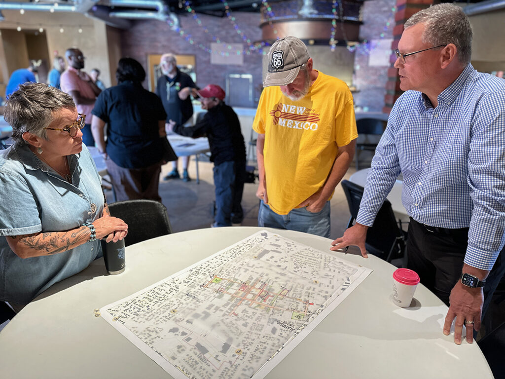 Public pin-up attendees discuss work-in-progress with David Weir, Deputy Director, Community Planning and Development.