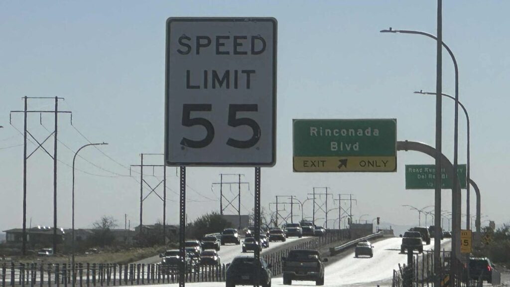 Speed limit sign along a road.
