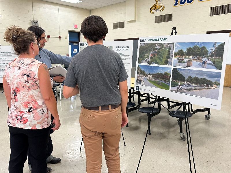 People looking at a poster on an easel