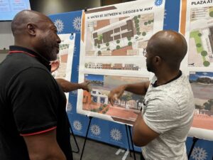 Designer Marques King discusses potential artist space with a meeting attendee.