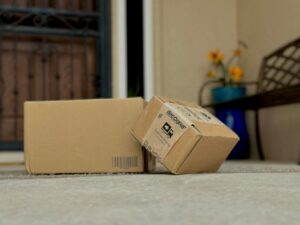 Two boxes on the ground with a bench in the background.