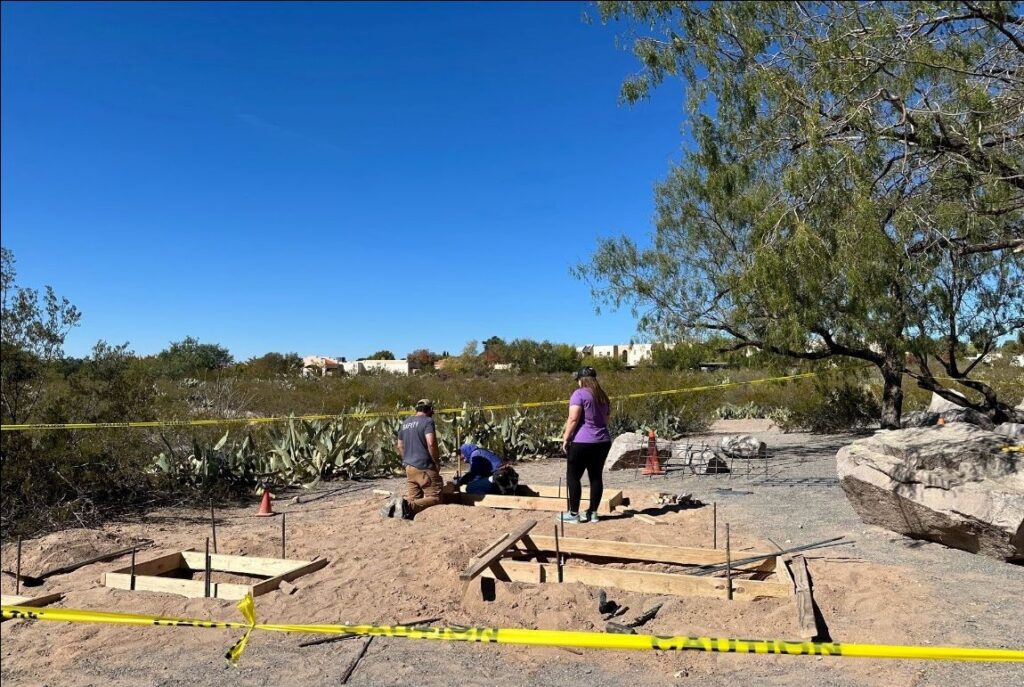 People working in the dirt at a park.