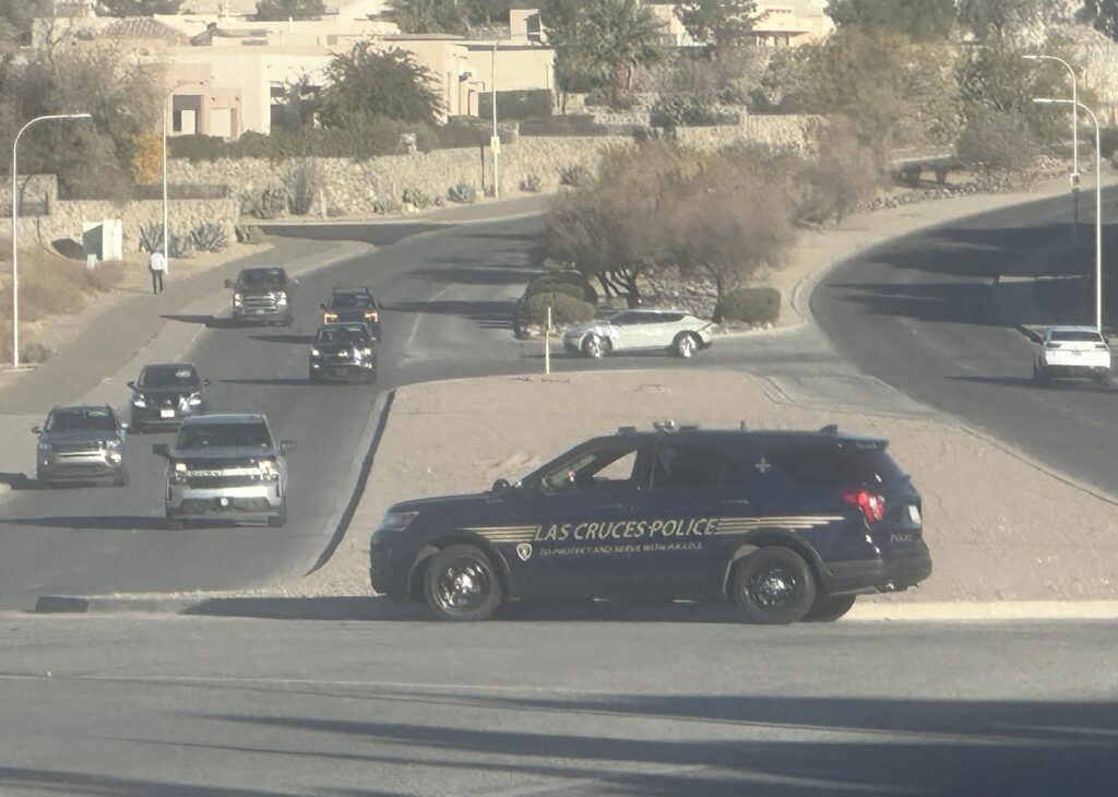 LCPD vehicle parked on the median with vehicles driving by.