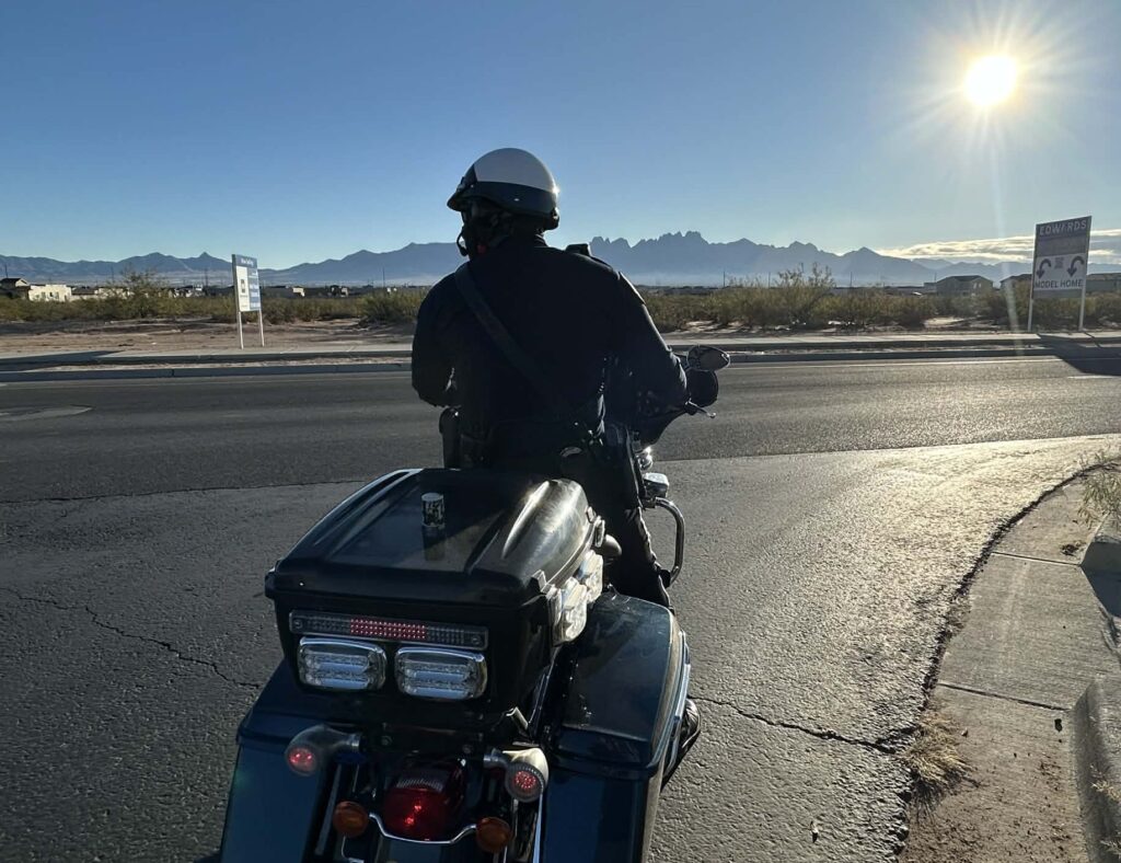Officer on his motorcycle on the side of the road.