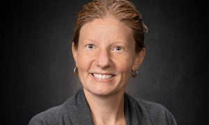 Portrait of Sara Gonzales against a black backdrop.