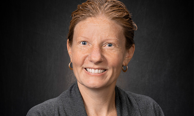 Portrait of Sara Gonzales against a black backdrop.