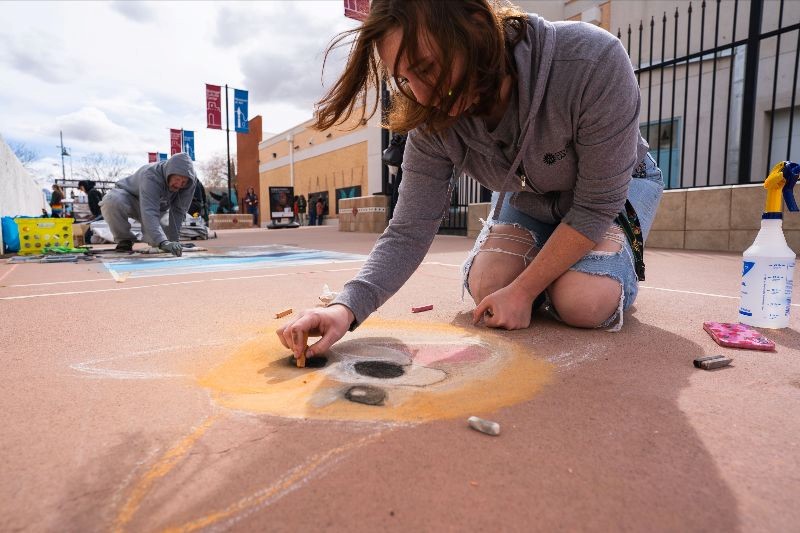 a photo of a person chalk drawing