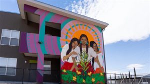 Photo of the tres hermanas mural on the side of one of the buildings of the tres hermanas affordable housing complex in Las Cruces.