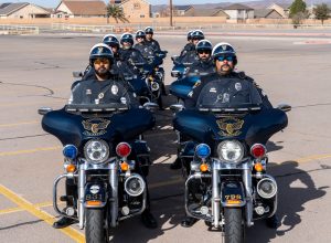 Las Cruces Police Officers on their motorcycles facing the camera in two lines of four officers on the right and 5 officers in the left line.