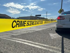 Crime scene tape displayed in a parking lot.