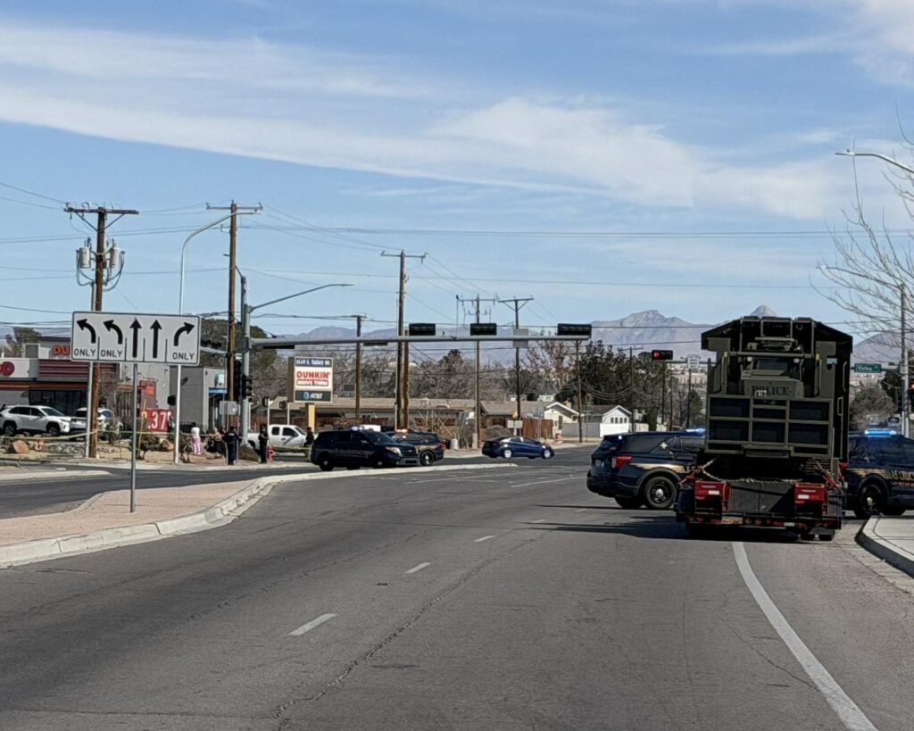 Police vehicles blocking an intersection.